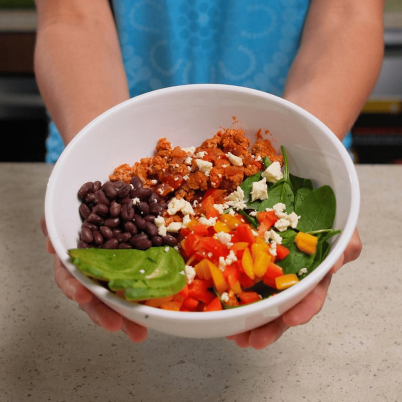 Taco bowl with beans , chicken and avocado