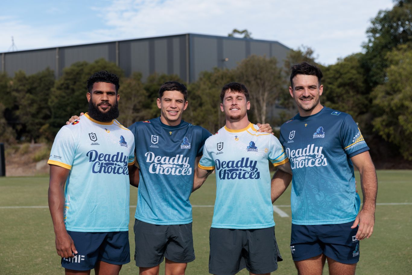 Gold Coast Titans players posing together in their Deadly Choices 715 Health Check shirts.